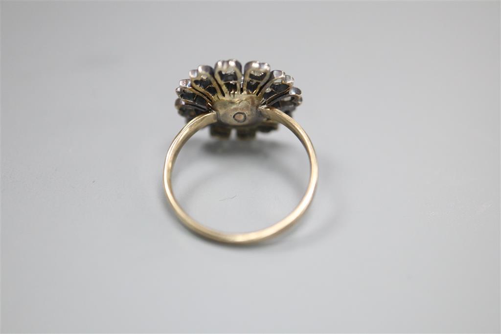 An antique yellow metal and diamond set circular cluster ring, (adapted?), size K/L, gross 3.5 grams,